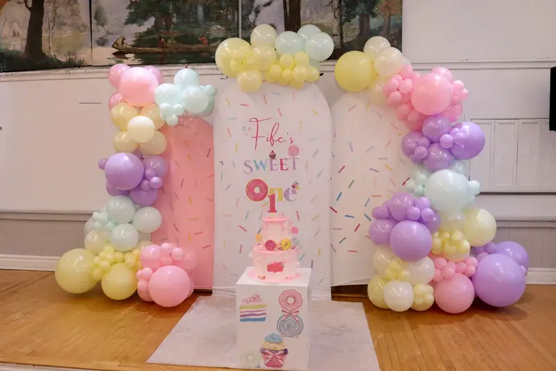 Pastel balloons and elegant birthday backdrop